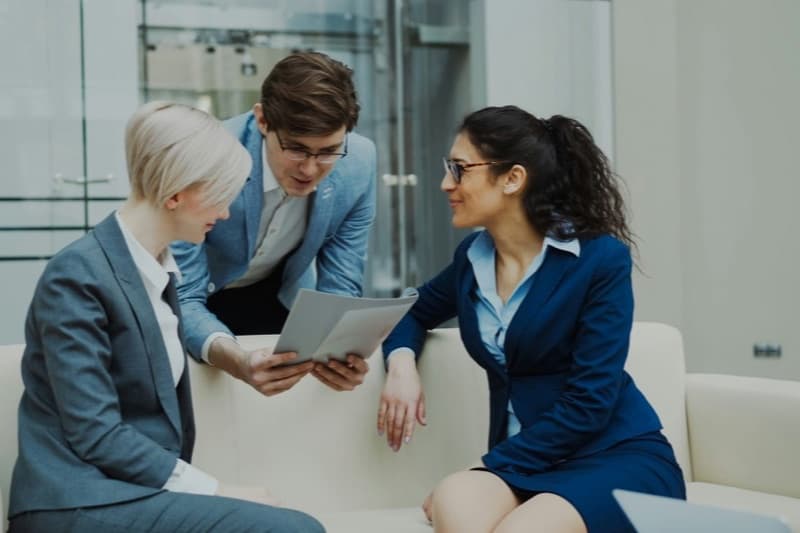 Business leaders reviewing AI policy documents together